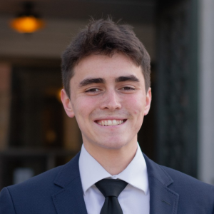 a man in a suit smiling