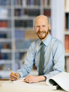 a person sitting at a desk writing