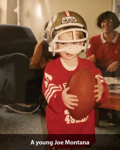 a boy wearing a helmet and holding a football