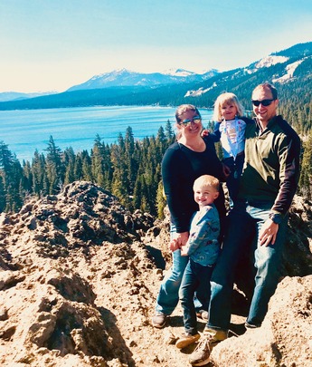 a group of people posing for a picture on a mountain