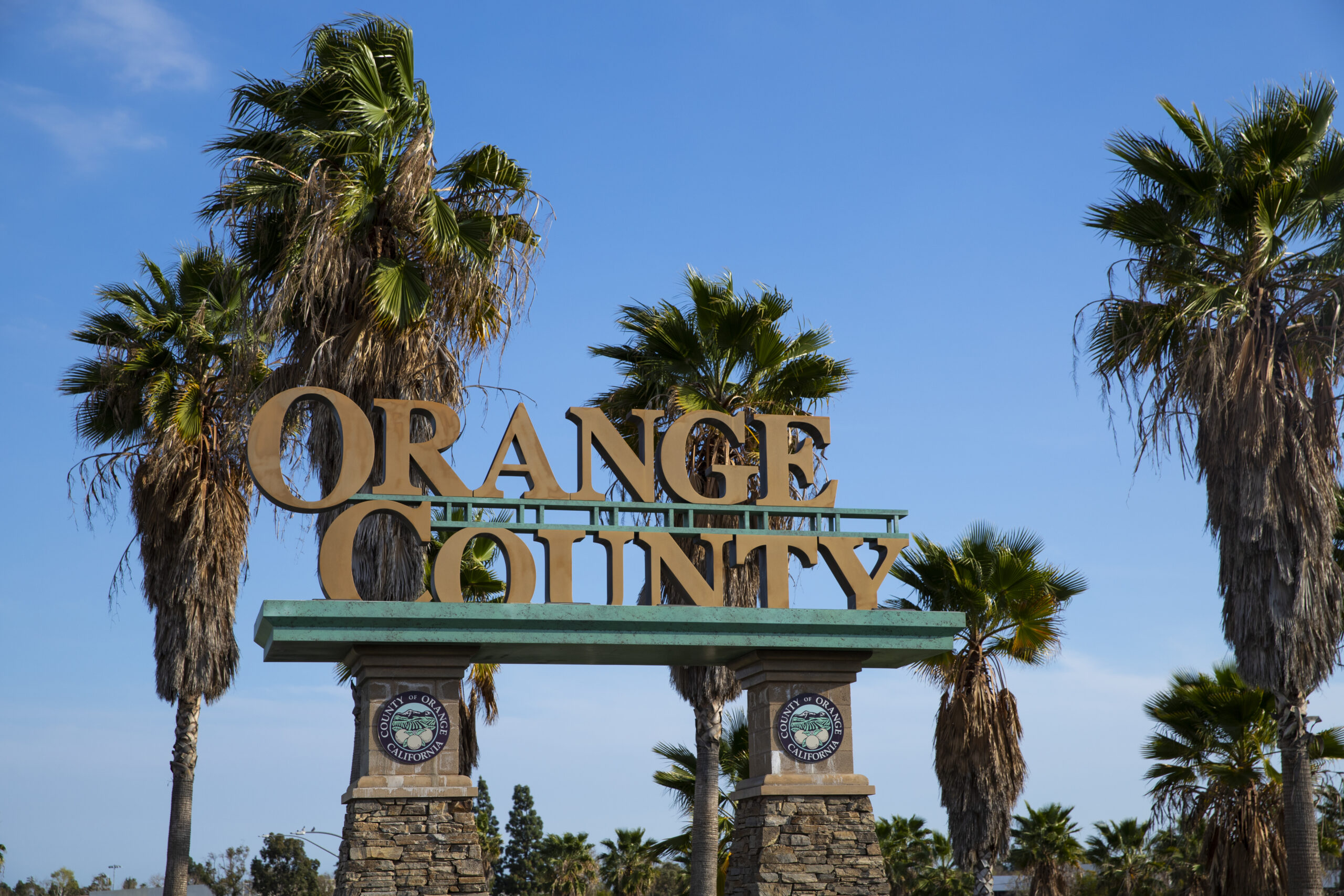 a sign with trees in the background